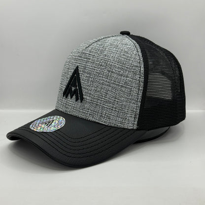 Gorra Trucker AMBULA - Edición "Textura Contraste" (Gris Jaspeado & Visera Símil Cuero Negra)